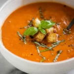 Creamy Tomato Basil Soup served with fresh basil