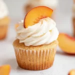 Vanilla Peach Cupcakes Garnished with Fresh Peaches
