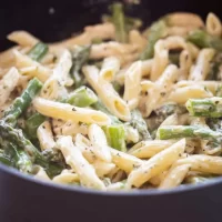 Delicious Chicken Asparagus Penne on a White Plate