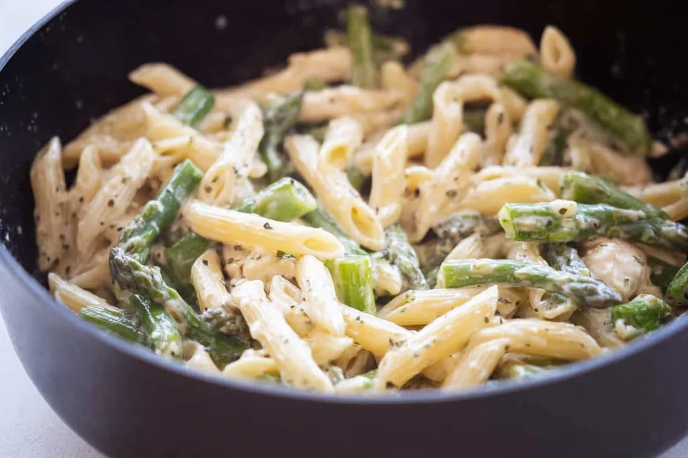 Delicious Chicken Asparagus Penne on a White Plate