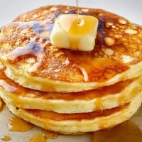 Classic Pancakes Stacked High with Syrup