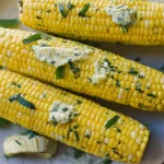 Herb Butter Melting on Grilled Corn on the Cob