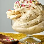 Vibrant Bowl of Frozen Banana Ice Cream Topped with Nuts