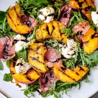Grilled Peach and Burrata Salad with Arugula and Balsamic Glaze Bliss Grilled Peach and Burrata Salad Close-Up