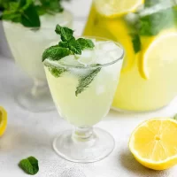 Homemade Lemonade with Fresh Mint: Refreshing Summer Delight Delicious Homemade Lemonade with Fresh Mint in a Glass