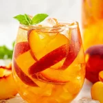Peach Sangria in a Pitcher with Fresh Peaches
