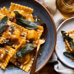 Homemade Pumpkin Ravioli Plated with Sage Butter